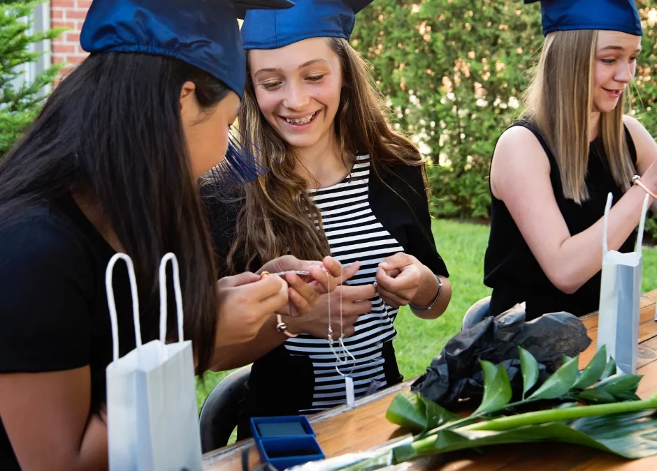 Graduating friends contemplating graduation party ideas in backyard